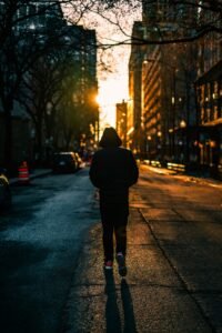 Man walking alone in a city during the evening, calm and reflective