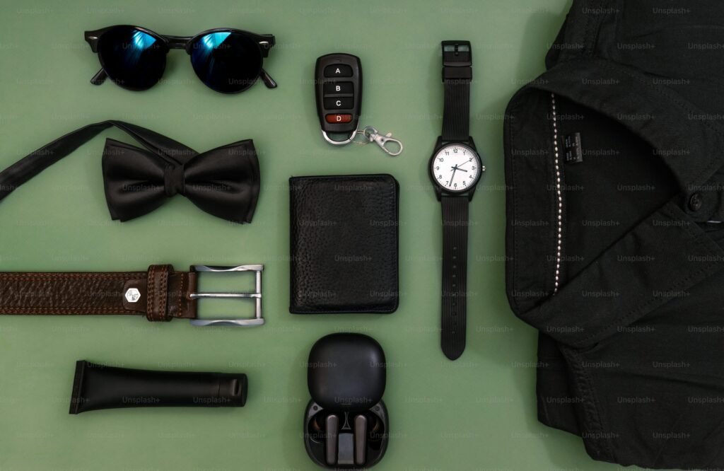 Professional man essentials including blazer, watch, grooming items, and work accessories
